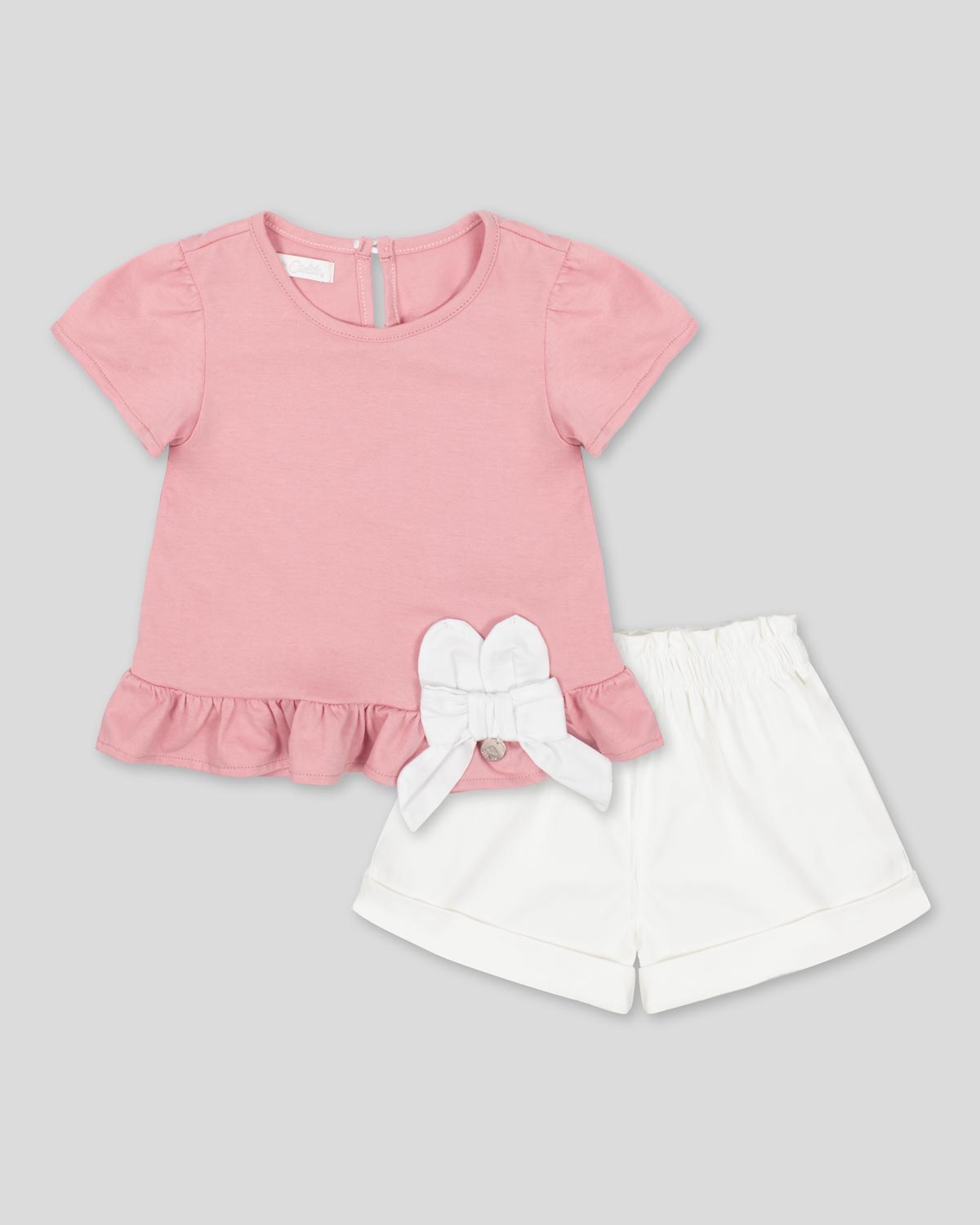 Conjunto blusa palo de rosa con moño y short blanco para bebé