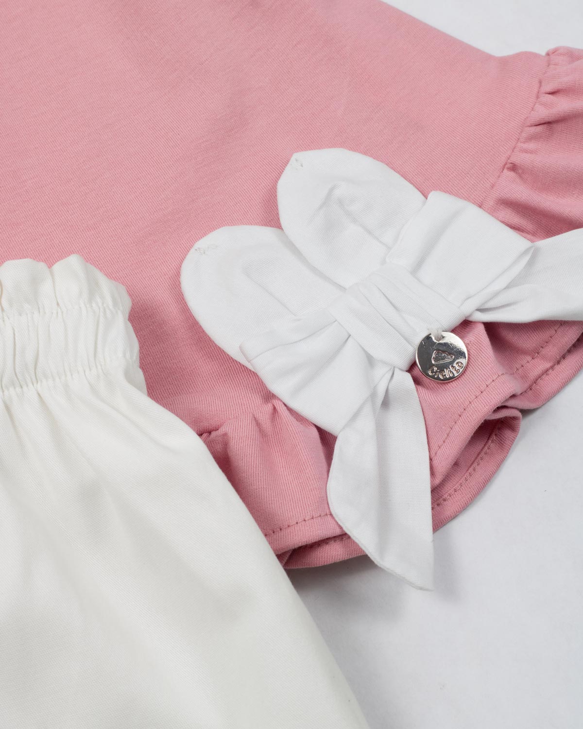 Conjunto blusa palo de rosa con moño y short blanco para bebé