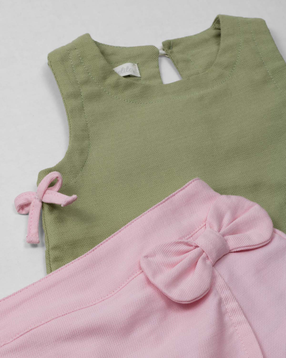 Conjunto blusa manga sisa verde con moñitos y short rosa para bebé niña
