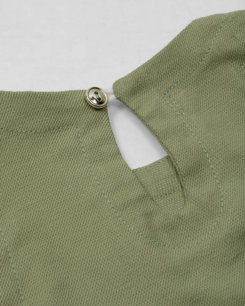 Conjunto blusa manga sisa verde con moñitos y short rosa para bebé niña