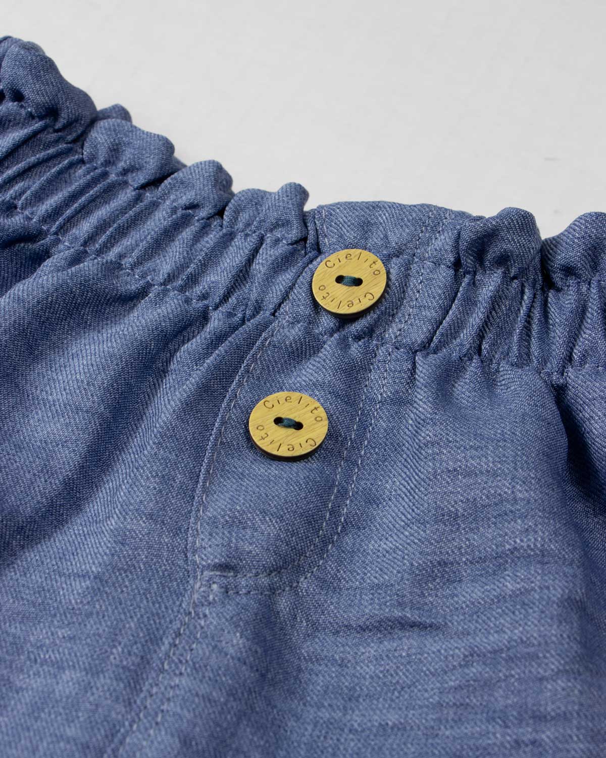 Conjunto blusa blanca con tela bordada de flores y short azul para bebé niña
