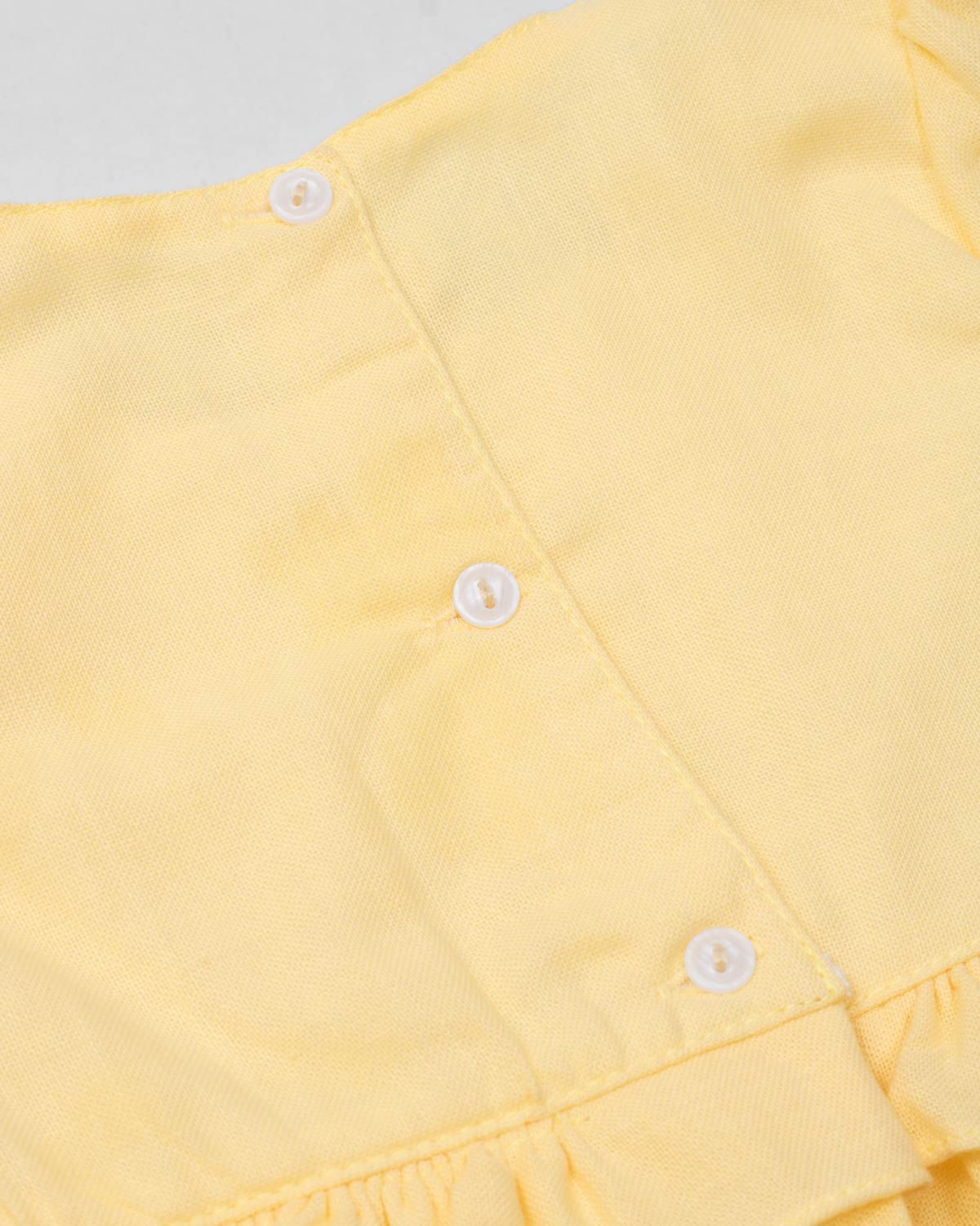 Vestido body en lino amarillo con osito tipo bolso para bebé niña