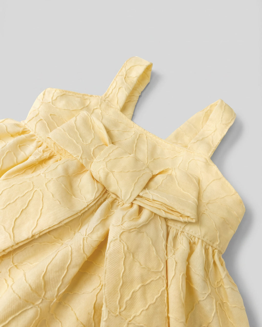 Vestido body amarillo con moño y flores bordadas para bebé niña