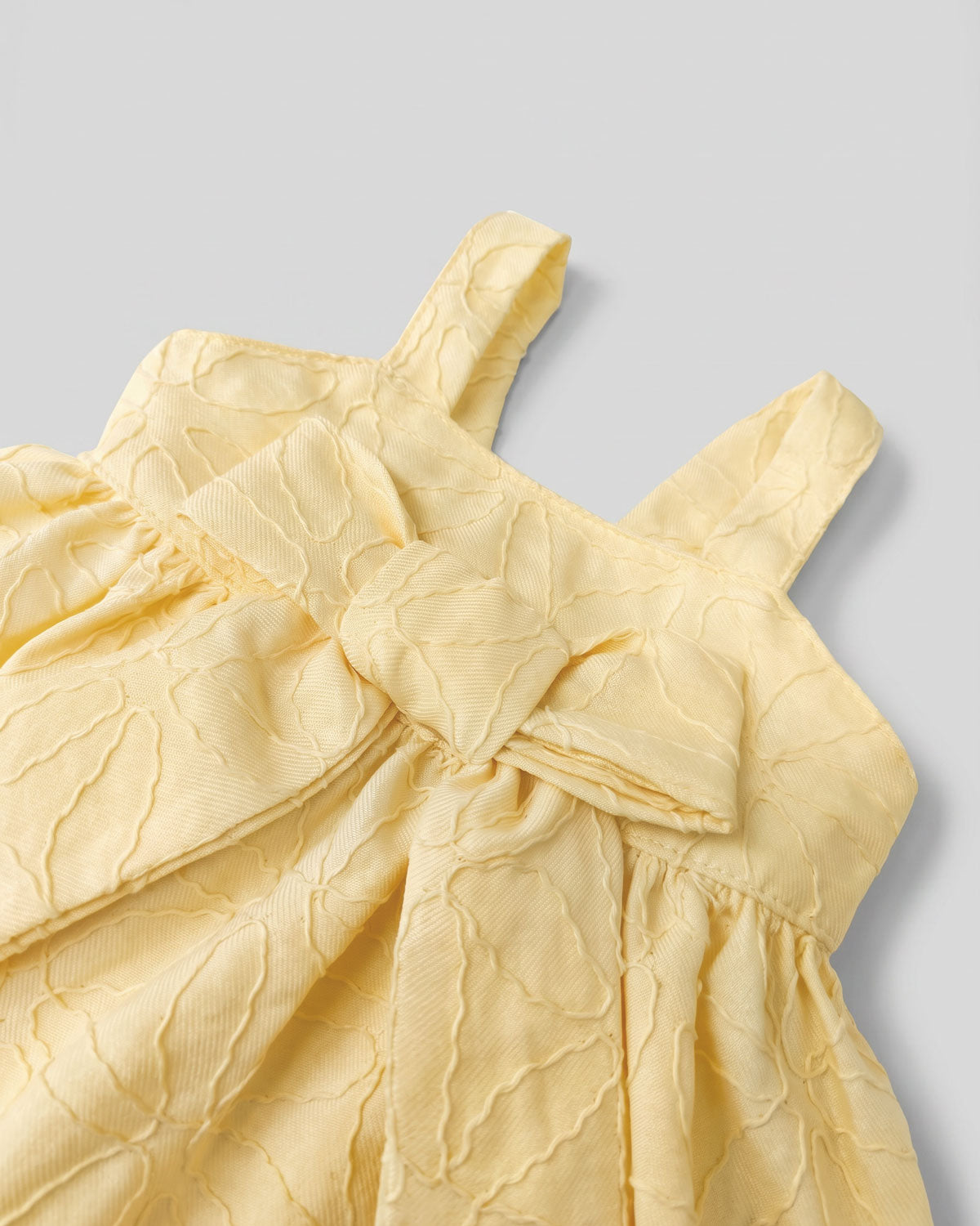 Vestido body amarillo con moño y flores bordadas para bebé niña