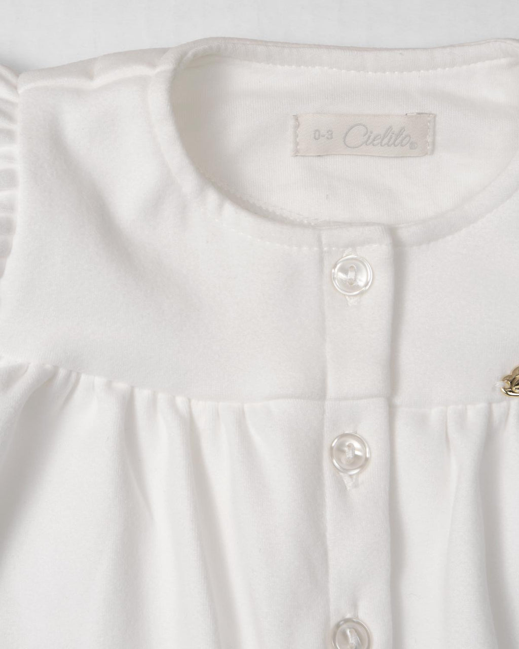 Pijama enteriza blanca con botones y boleros para recién nacida