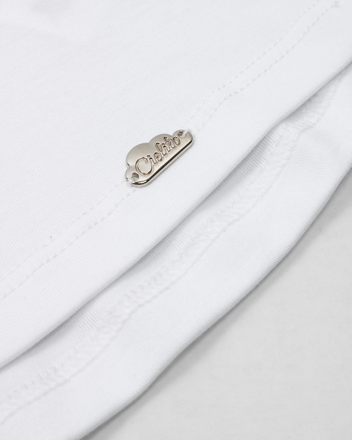 Conjunto blusa blanca con moños estampados en hombro y short rosa con bolsillos para niña