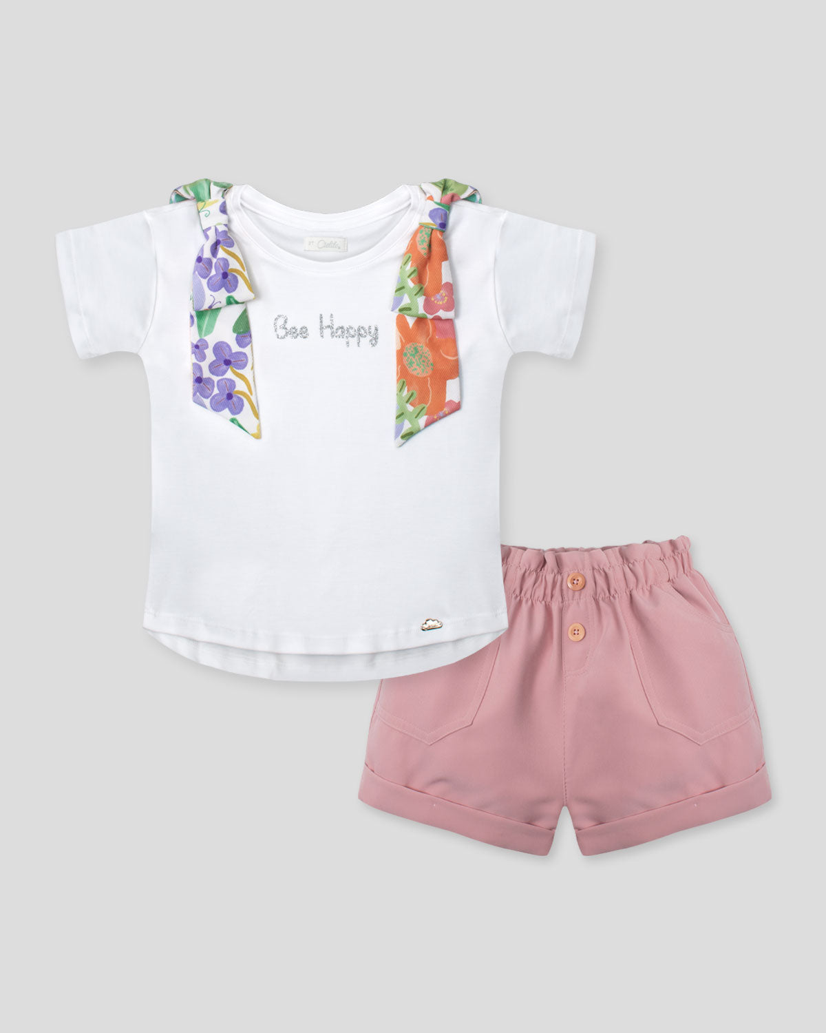 Conjunto blusa blanca con moños estampados en hombro y short rosa con bolsillos para niña
