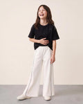 Conjunto blusa negra con moñitos y pantalón blanco para niña