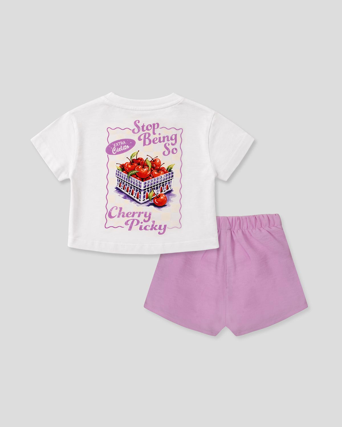 Conjunto camiseta blanca estampada y falda short lila con moños para niña