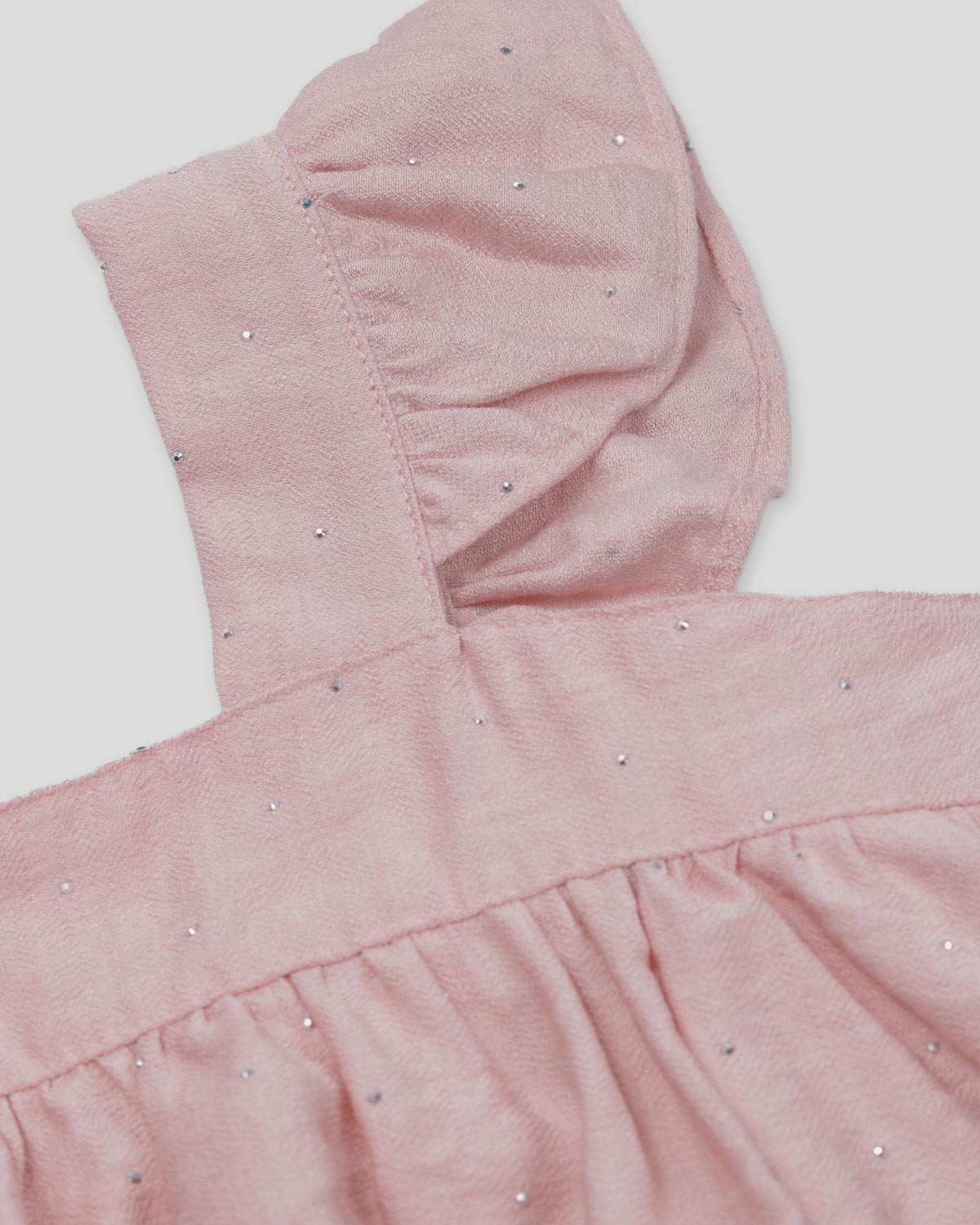 Blusa rosa con brillos y tiras con boleritos para niña