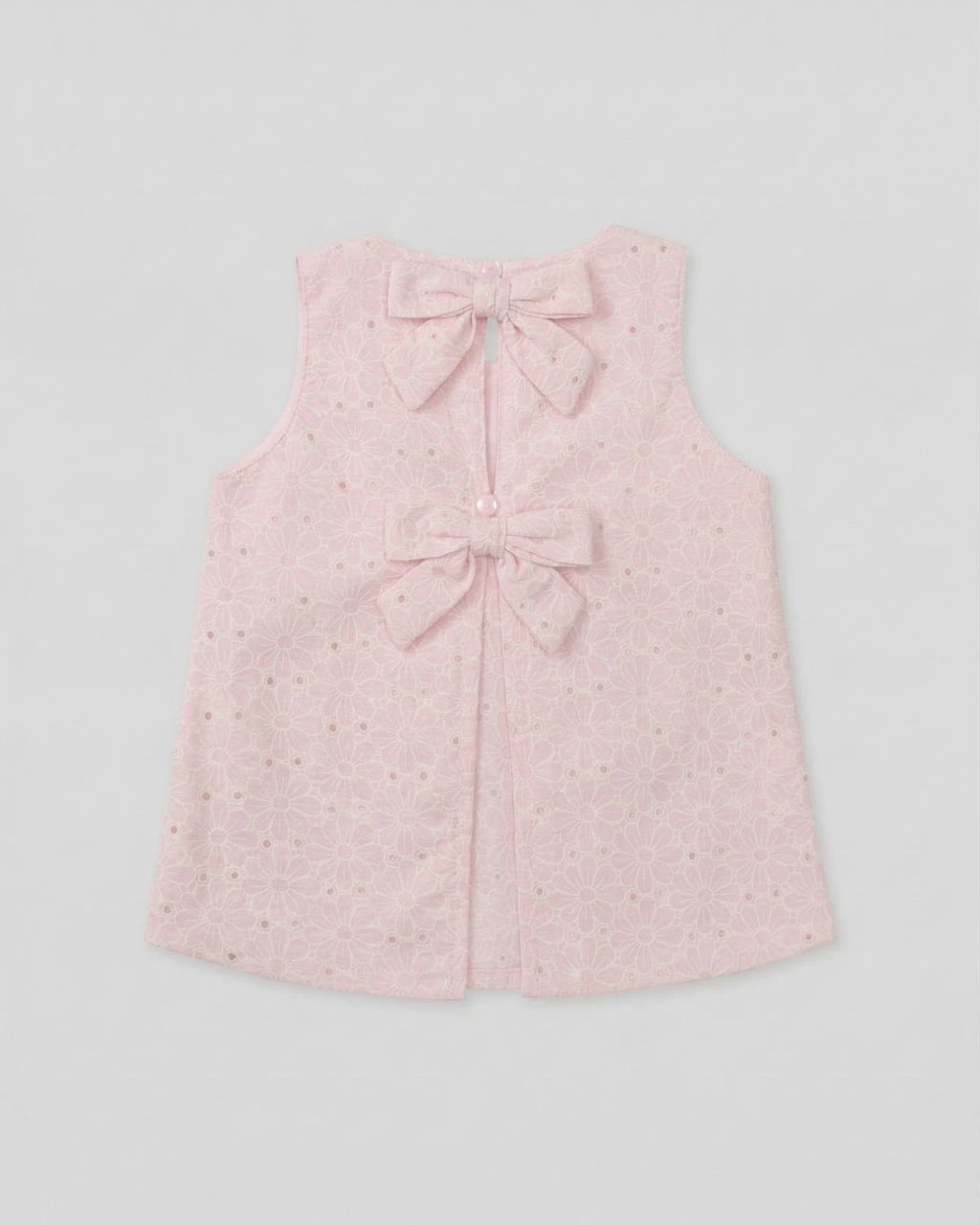 Blusa tela hoja rota rosa con moños para niña