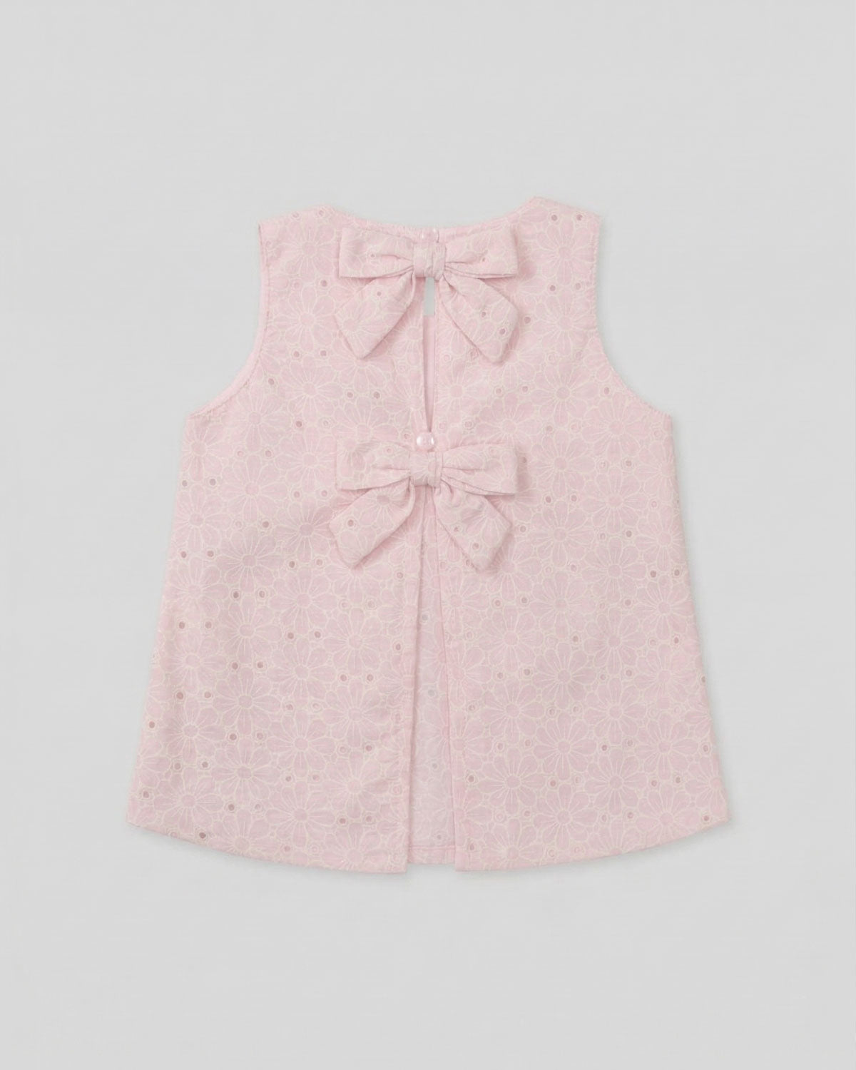 Blusa tela hoja rota rosa con moños para niña