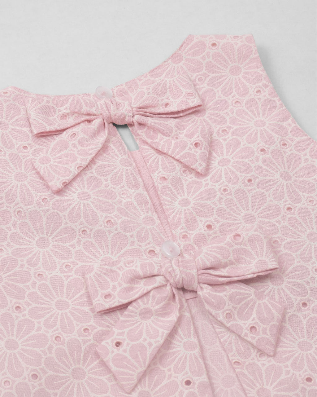 Blusa tela hoja rota rosa con moños para niña