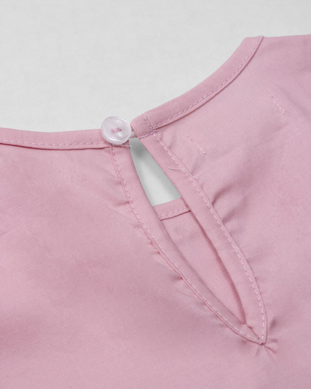 Blusa rosa con moños negros para niña