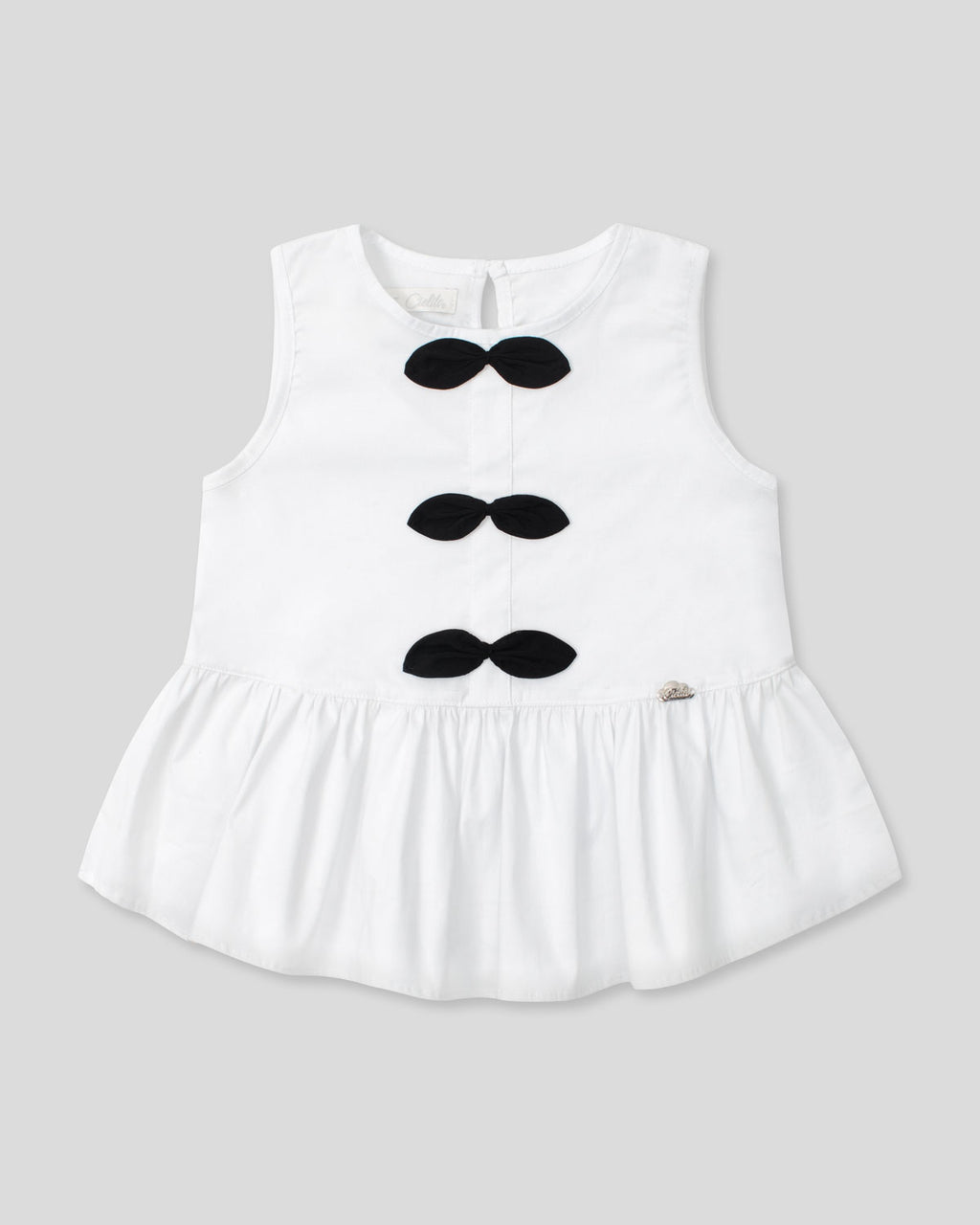 Blusa blanca con moños negros para niña