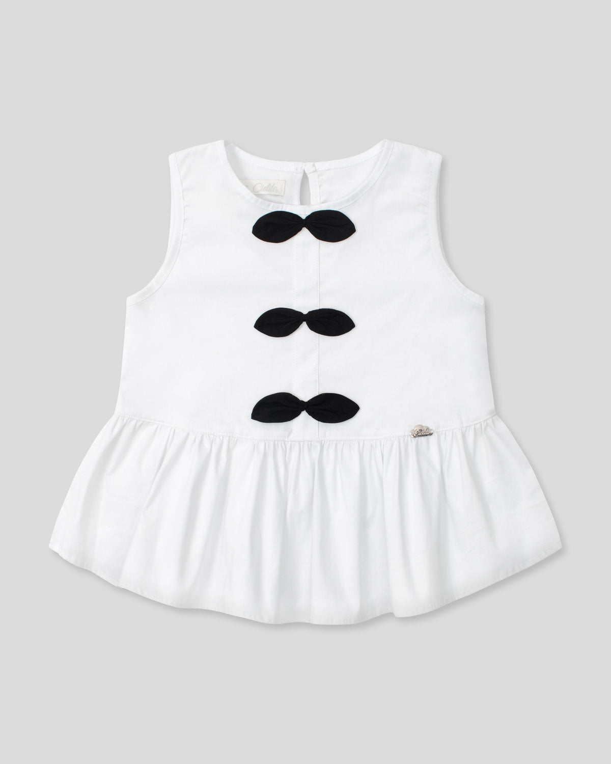Blusa blanca con moños negros para niña