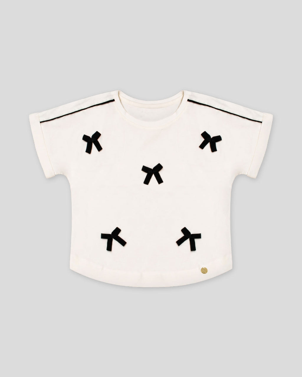 Blusa blanca con moñitos para niña