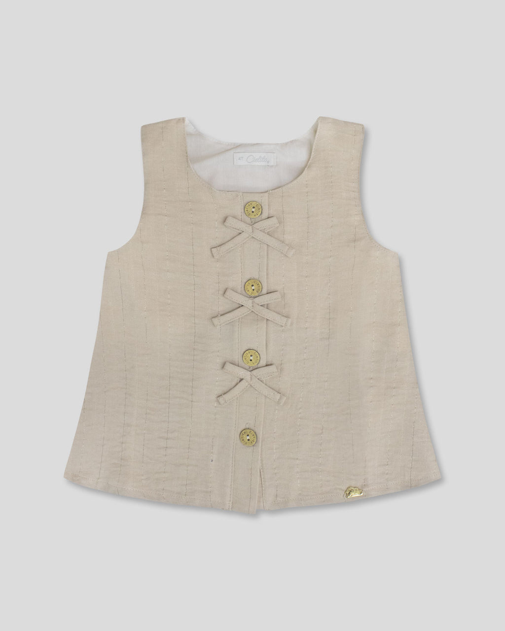 Blusa  beige con botones y moñitos para niña