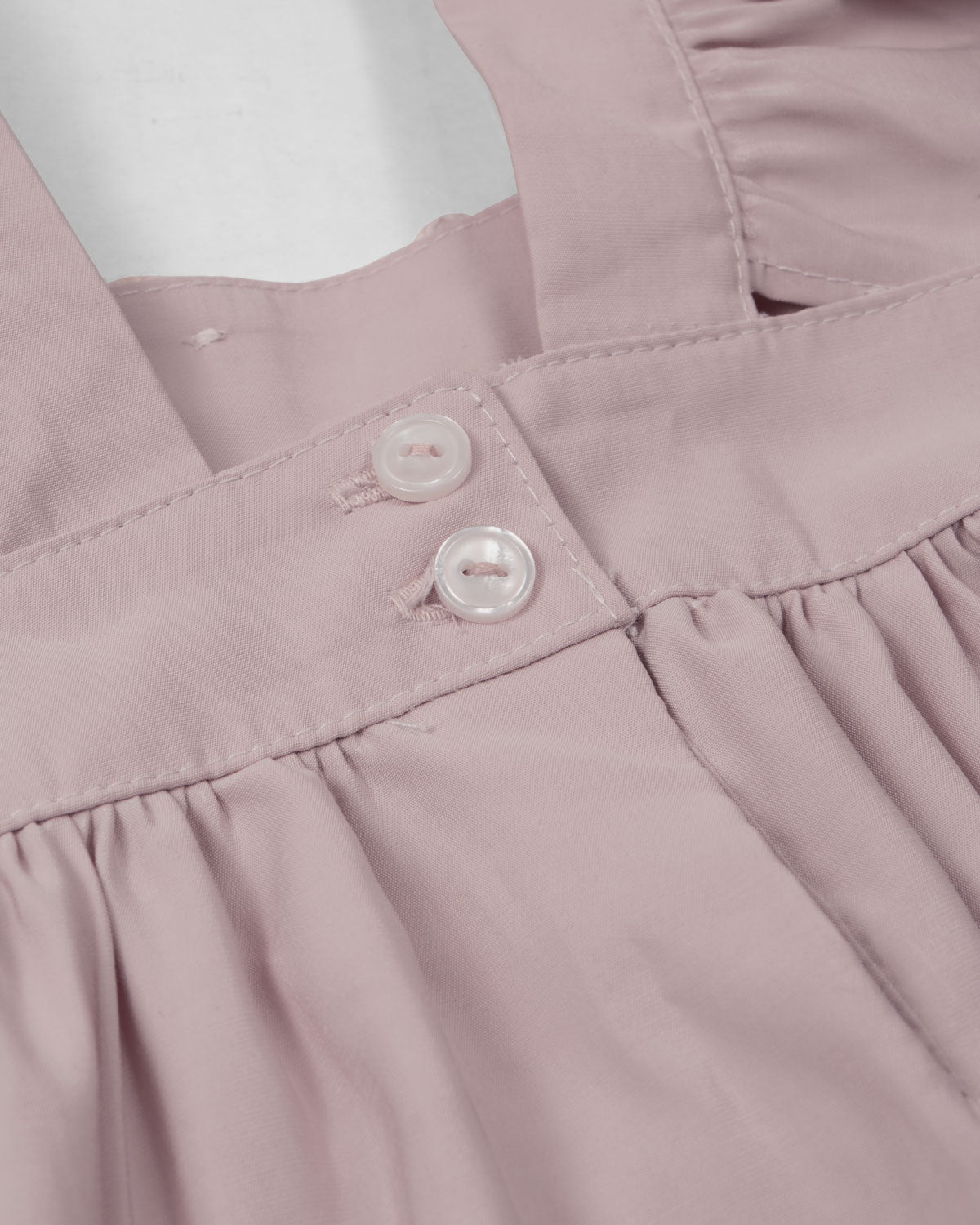 Vestido rosa de tiras con boleros y apliques de flor para niña