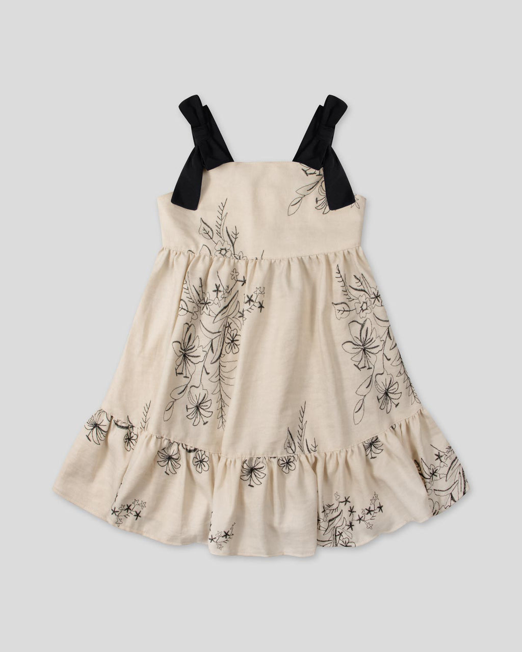 Vestido crema con diseño de flores tejido y tiras con moño para niña