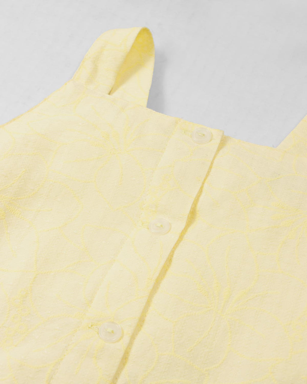 Vestido amarillo con moños y estampado floral para niña