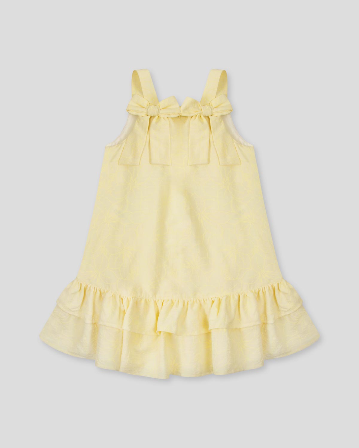 Vestido amarillo con moños y estampado floral para niña