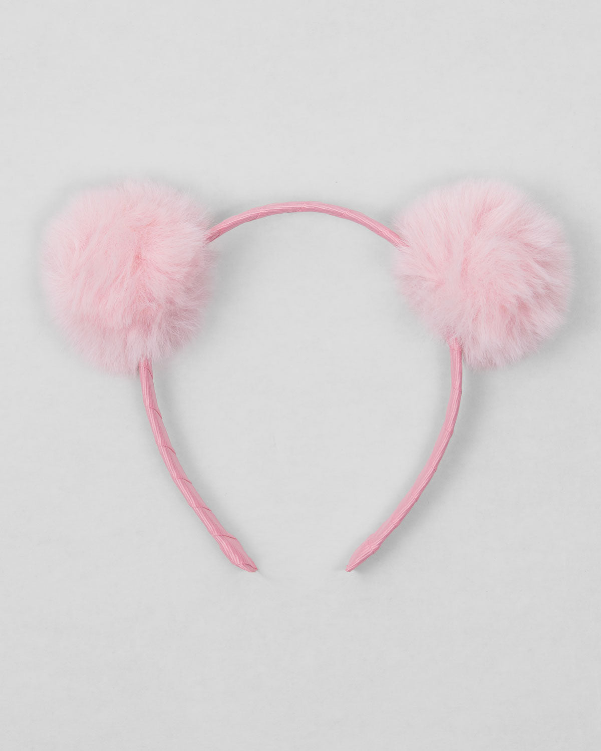 Diadema rosa con pompones para niña