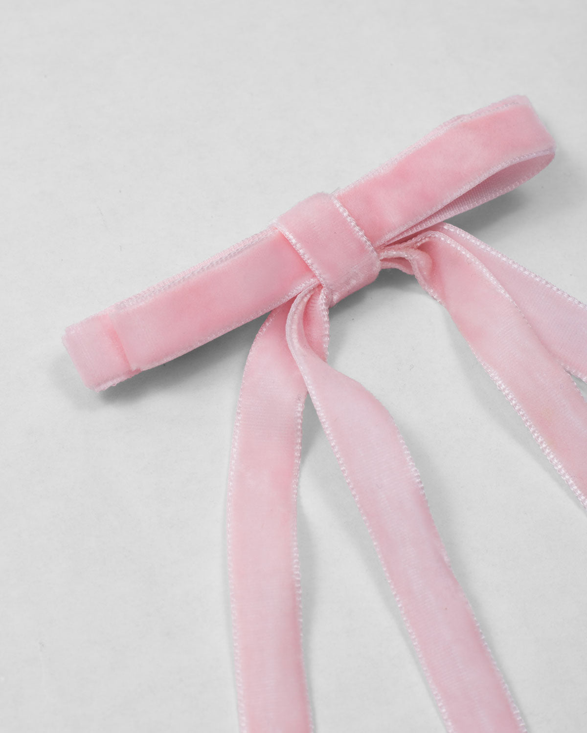 Moño pinza de cintas rosa