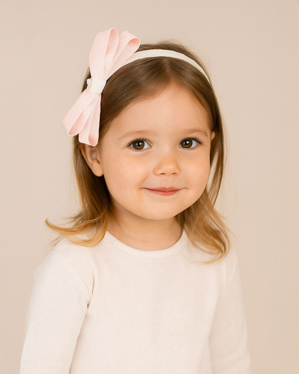 Diadema con moño rosa para niña